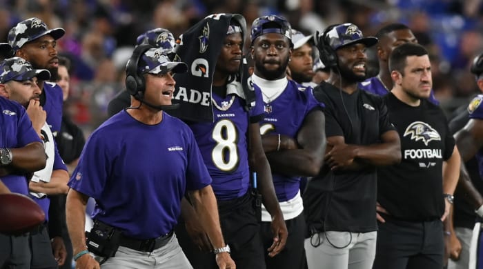 Aug 11, 2022; Baltimore, Maryland, USA; Baltimore Ravens head coach John Harbaugh reacts while standing with quarterback Lamar Jackson (8) during the game against the Tennessee Titans at M&T Bank Stadium.
